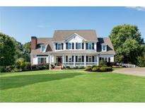 Traditional two-story home with a lush lawn and a welcoming front porch with black shutters and columns at 1525 Thomas Rd, Canton, GA 30115