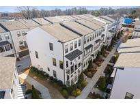 Stylish townhouse exteriors featuring balconies, manicured landscaping, and modern design elements at 1756 Morningtide Ne Ln, Atlanta, GA 30324