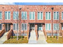 Modern brick townhomes featuring symmetrical design and manicured landscaping at 145 Devore Rd, Alpharetta, GA 30009