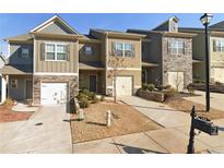 Attractive townhome exterior boasts stone accents, individual driveways, and inviting curb appeal at 266 Valley Xing, Canton, GA 30114