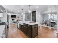Bright kitchen featuring hardwood floors, a center island, modern lighting, and white countertops at 470 River Valley Rd, Atlanta, GA 30328