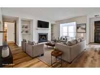 Bright living room features a fireplace, built-in shelves, and wood floors at 313 River Mill Cir # 313, Roswell, GA 30075