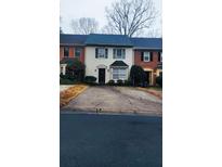Charming townhouse featuring a well-maintained front lawn and classic architectural details at 465 Salem Woods Se Dr, Marietta, GA 30067