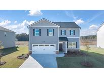 Charming two-story home featuring a two-car garage, landscaped yard and classic architectural design at 8597 Secretariat Dr, Lithonia, GA 30058
