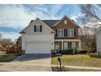 Charming two-story home with a manicured lawn, lovely landscaping, and a two car garage at 301 Ridgewood Trl, Canton, GA 30115