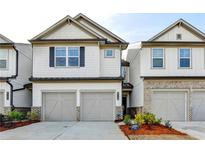 Charming townhome featuring a two-car garage, and beautifully landscaped front yard at 4118 Haleston Rd, Duluth, GA 30097