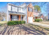 Charming two-story home with brick accents, well-manicured bushes, and attached one car garage at 2413 Charleston Pointe Ct, Atlanta, GA 30316