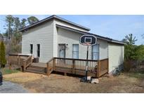 Charming home with a large wooden deck and a basketball hoop, perfect for outdoor fun at 2100 Driftwood Cir, Cumming, GA 30041