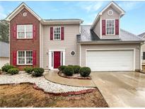 Charming two-story home with a well-maintained lawn and attached two-car garage at 1434 Stephens Pond Vw, Loganville, GA 30052