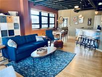 Stylish living room boasts an open floor plan, bar seating, and large windows for abundant natural light at 878 Peachtree Ne St # 608, Atlanta, GA 30309