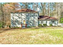 Charming two-story home with light-green siding, traditional windows, and a well-maintained front lawn at 220 Mimosa Dr, Fayetteville, GA 30214