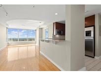 Bright living room featuring hardwood floors, a modern kitchen, and large windows with a stunning city view at 3338 Peachtree Ne Rd # 2308, Atlanta, GA 30326