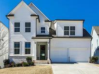 Charming two-story home with a two car garage and a welcoming green front door at 108 Fieldbrook Xing, Holly Springs, GA 30115