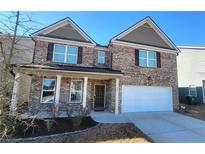 Charming two-story brick home with a well-manicured lawn and an attached two-car garage at 7157 Gladstone Cir, Stonecrest, GA 30038
