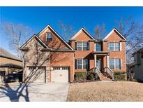 Charming brick home with a well-manicured lawn and two-car garage at 2326 Roberts View Trl, Buford, GA 30519