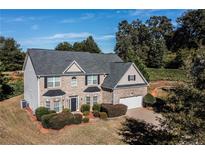 Two-story home featuring brick accents, a well-manicured lawn, and a two-car garage at 505 Mellview Ct, Stockbridge, GA 30281