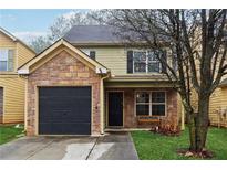 Charming two-story home with stone accents and a well-maintained front yard at 1042 Wedgewood Ct, Conyers, GA 30012