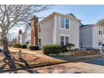 Inviting townhouse featuring a brick chimney and well-maintained landscaping at 4267 Parkview Ct, Stone Mountain, GA 30083