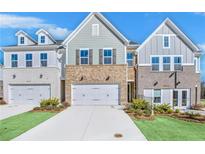 Charming townhome showcases a mix of brick and siding, complemented by a well-manicured lawn at 5769 Tillman Way, Powder Springs, GA 30127