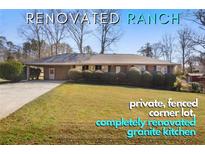 Charming renovated ranch with fenced corner lot and beautifully manicured front lawn at 1004 Powell Wright Rd, Marietta, GA 30066