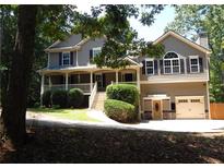 Charming two-story home featuring a welcoming front porch and a well-maintained landscaped yard at 132 Hammond Dr, Canton, GA 30114