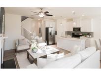 Bright and airy living room flows into kitchen, featuring modern finishes and lots of natural light at 1597 Aiden Way # 47, Conyers, GA 30013