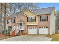 Charming two-story brick home with a well-maintained lawn and attached two-car garage at 4030 Staghorn Ct, Douglasville, GA 30135