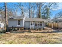 Charming home with gray siding, tidy landscaping, and a convenient covered carport at 4981 Crowe Se Dr, Smyrna, GA 30082