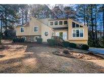 Inviting two-story home featuring a unique architectural design and manicured front yard at 2010 Shadow Bluff Ne Ct, Marietta, GA 30062