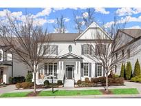 Charming two-story home with manicured landscaping, a covered front porch, and classic architectural details at 220 Chastain Park Ne Dr, Atlanta, GA 30342