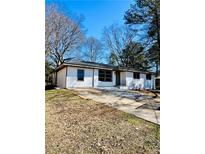 Inviting home with a well-maintained lawn, fresh white paint, and a classic design at 2213 Sandtown Sw Rd, Marietta, GA 30060