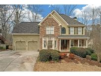 Charming two-story home featuring a stone facade, covered front porch, and a well-maintained front yard at 582 Braidwood Nw Dr, Acworth, GA 30101