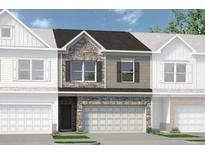Charming townhome featuring a stone and siding exterior, two-car garage, and well-manicured landscaping at 16 Jacobs Farm Ln # 8, Lawrenceville, GA 30045