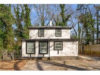 Charming two-story home with a modern color scheme and well-maintained landscaping at 2802 Palm Dr, Atlanta, GA 30344