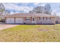 Charming single-story home featuring a spacious yard and a convenient two-car garage at 1408 Lake Paradise Rd, Villa Rica, GA 30180