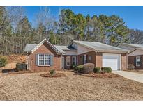 Charming brick home featuring an attached garage and a well-maintained front yard at 175 Lagrange Ct, Fayetteville, GA 30214