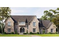 Stunning new traditional home with a brick facade, arched entry, and professionally landscaped lawn at 133 Laurel Brook Ln, Canton, GA 30115