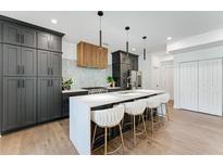 Modern kitchen features gray cabinets, a large island with seating, and stainless steel appliances at 2809 Glenwood Ave, Atlanta, GA 30317