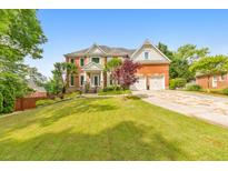 Beautiful two-story brick home with a well-manicured lawn and attached two-car garage at 1250 Rosette Way, Marietta, GA 30062