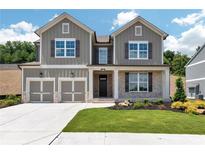 Charming two-story home featuring a two-car garage and beautifully landscaped front yard at 329 Willow Cv, Canton, GA 30114