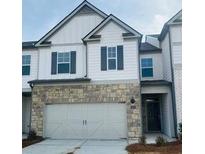 Charming two-story townhome with a stone facade and a two-car garage at 2474 Bayberry St # 33, Acworth, GA 30101