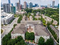 A stunning aerial view of a townhome community with the city skyline in the background at 3635 E Paces Ne Cir # 1405, Atlanta, GA 30326