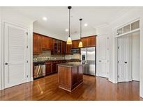 Well-equipped kitchen with stainless steel appliances, an island, and wooden cabinetry at 3635 E Paces Ne Cir # 1405, Atlanta, GA 30326