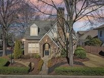 Charming brick home featuring manicured landscaping, mature trees, and a classic architectural design at 460 High Pointe Trl, Roswell, GA 30076
