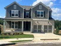 Charming two-story home featuring a brick facade and a two-car garage at 219 Willow St, Canton, GA 30114