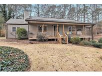 Charming home with inviting front porch and mature landscaping offers serene curb appeal at 4352 Treeline Way, Douglasville, GA 30135