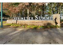 Stone Perimeter Summit community sign surrounded by mature trees and greenery in a landscaped setting at 10 Perimeter Summit Ne Blvd # 4243, Brookhaven, GA 30319