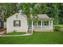 Charming bungalow featuring a covered porch and freshly painted exterior and a well manicured lawn at 1273 Boulevard Lorraine Sw, Atlanta, GA 30311