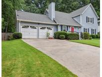 Charming two-story home featuring a two-car garage, well-manicured lawn, and a classic architectural design at 1004 Natalie Se Ln, Smyrna, GA 30082