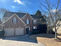 Charming two-story brick home with a two-car garage and well-maintained landscaping at 2595 Chandler Grove Dr, Buford, GA 30519
